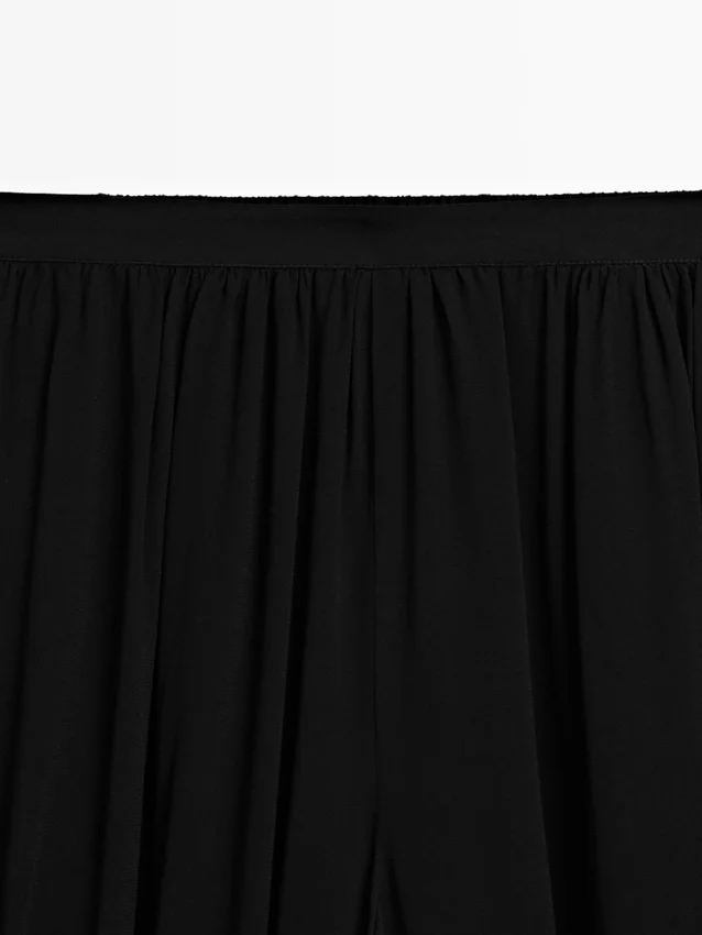 Pantaloni sarouel semitrasparenti con dettagli a bottoni Pantaloni sarouel semitrasparenti con dettagli a bottoni