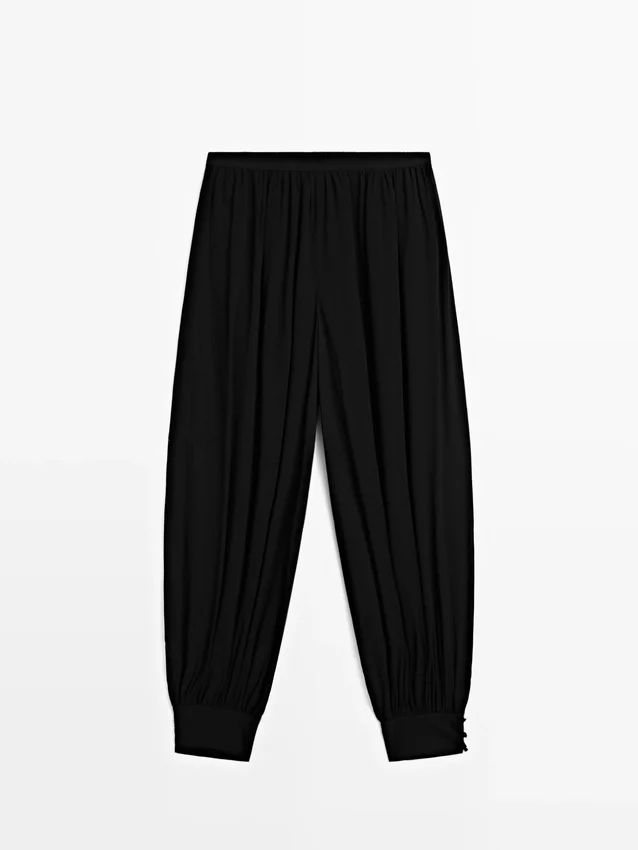 Pantaloni sarouel semitrasparenti con dettagli a bottoni Pantaloni sarouel semitrasparenti con dettagli a bottoni