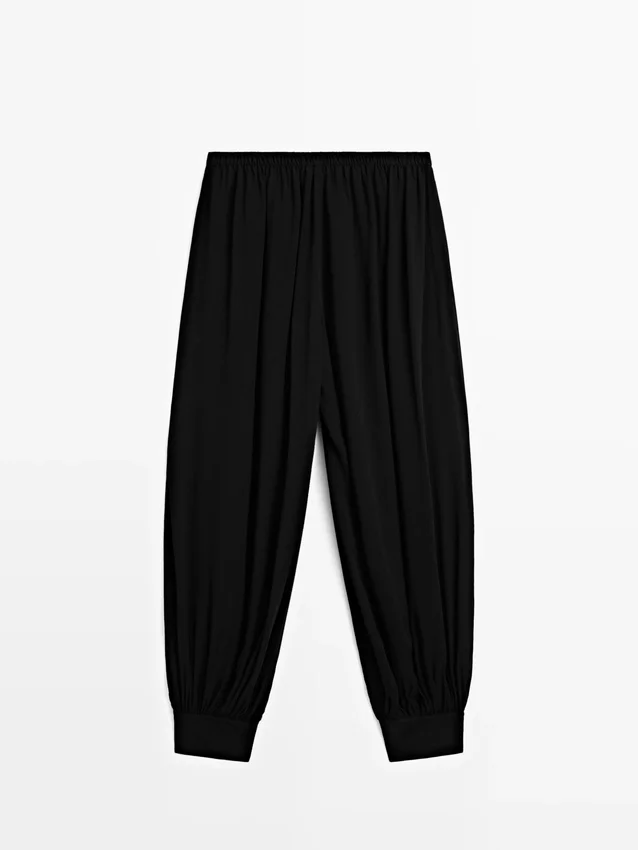 Pantaloni sarouel semitrasparenti con dettagli a bottoni Pantaloni sarouel semitrasparenti con dettagli a bottoni